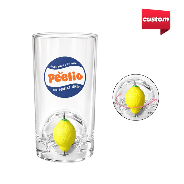 A clear glass cup featuring a yellow custom spinner toy inside. The cup has a logo on it.