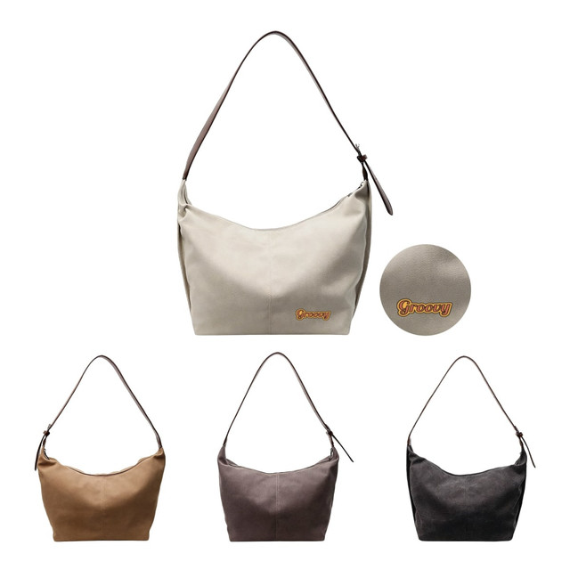 A canvas tote bag in cream, brown, grey, and black, featuring a logo. It has a shoulder strap for easy carrying.