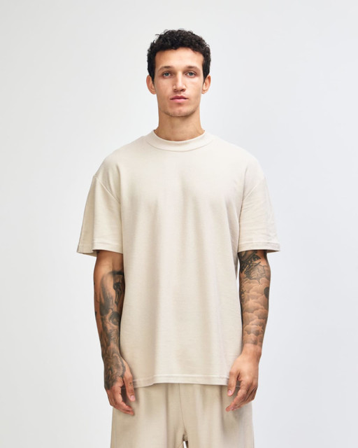 Unisex mockneck T-shirt in a neutral beige colour, featuring a relaxed fit and logo detail.