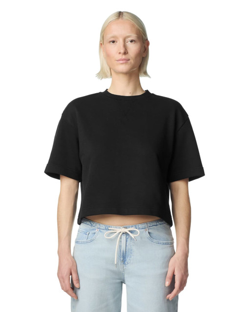 A black, mid-length boxy top for women made of French terry material, featuring a relaxed fit and short sleeves.