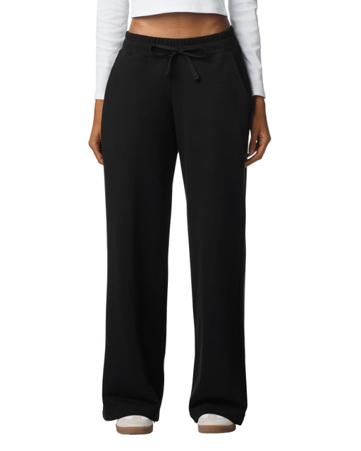 Wide leg pants in black with a drawstring waist, featuring a relaxed fit and pockets. The model is wearing a long-sleeved top.