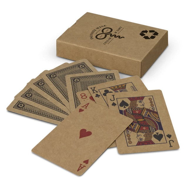 A set of kraft playing cards fanned out beside a kraft box, featuring red and black designs on the cards.