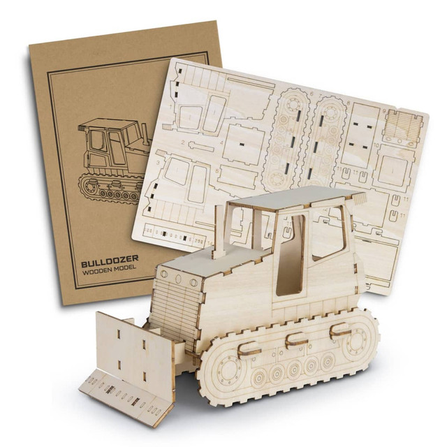 A wooden bulldozer model in natural wood tones, with packaging and assembly sheets displayed behind it.