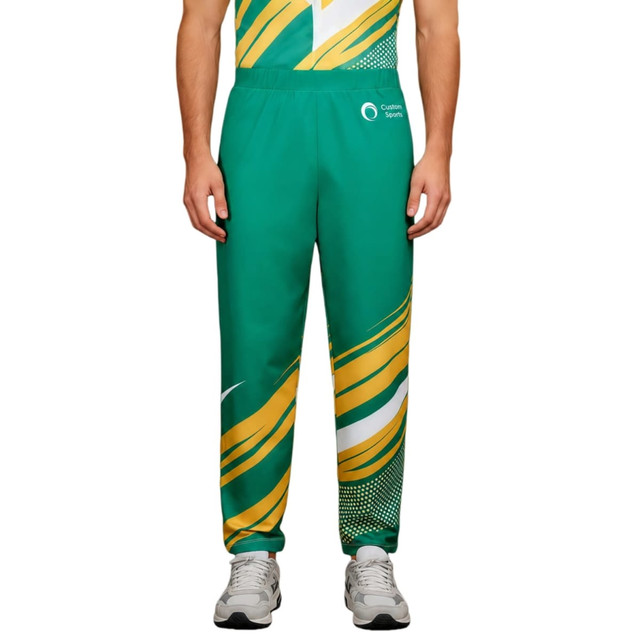 Unisex adult pants in green and yellow with a sublimated design and an elastic waistband. Features a logo.