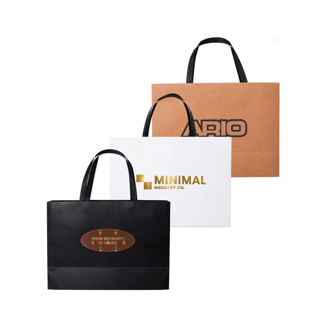 Three small paper bags with flat handles in brown, white, and black, featuring various logos and designs.