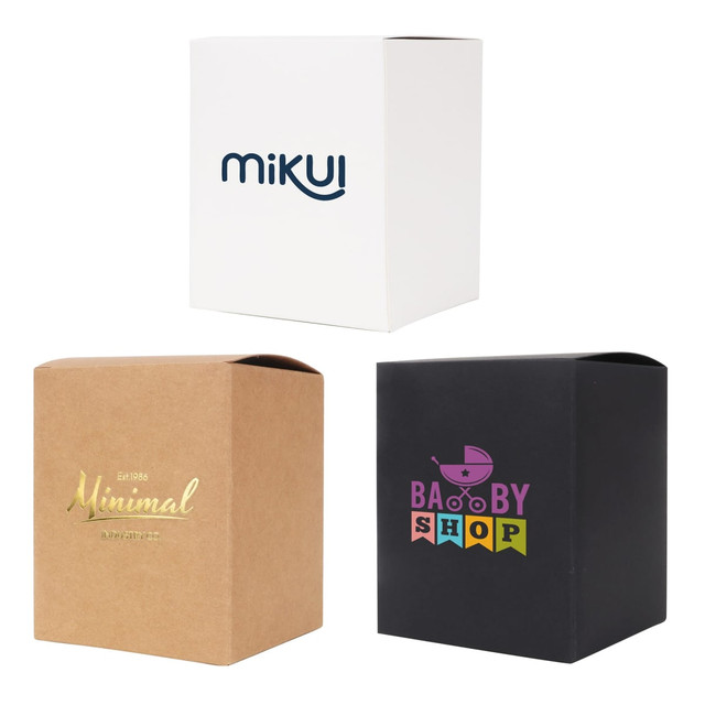Three large square gift boxes in white, kraft brown, and black, featuring different logos and designs.