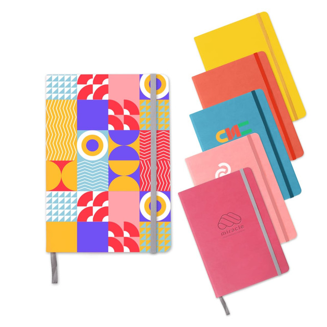 A5 PU cover notebook in a colourful geometric pattern alongside solid-coloured notebooks. All notebooks feature elastic closures.