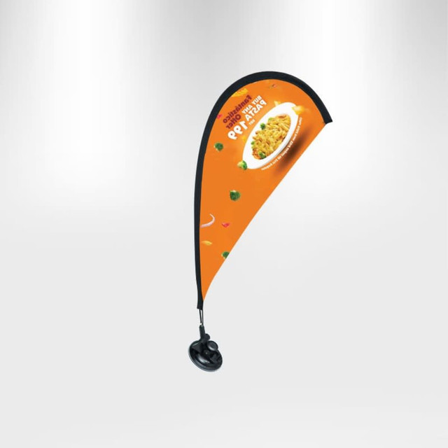 A teardrop flag with an orange background and a black suction cup base, featuring a logo and food imagery.