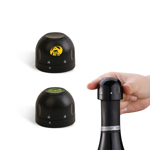 A drink bottle stopper in black, with two interchangeable tops and a hand holding one, featuring a logo.