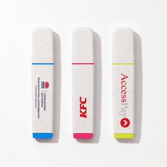 Three highlighters in biodegradable casing: blue, pink, and yellow, featuring various logos.