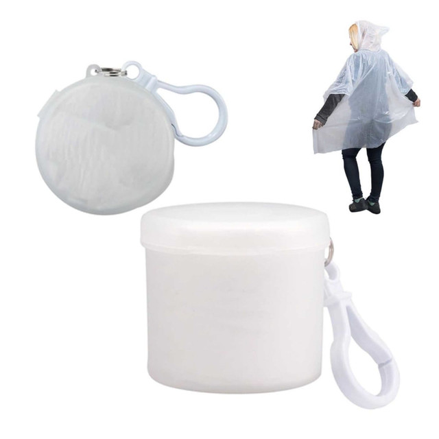A compact, white Cloud Poncho in a round storage case, with a clip for easy attachment.