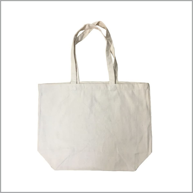 A tote bag in natural beige with two handles and a simple design. It features a blank canvas surface.