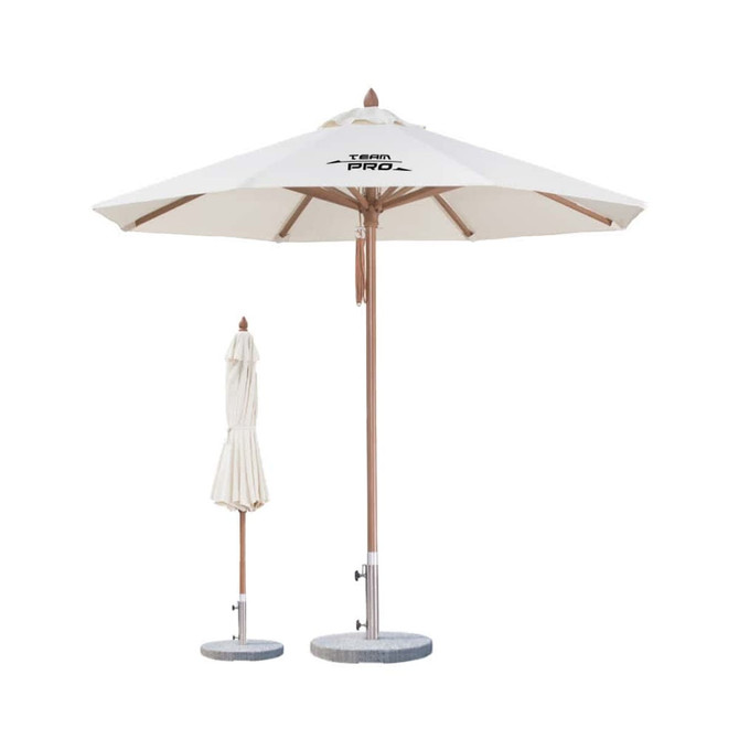 A 4x4m wind-resistant octagon outdoor umbrella in white with a wooden pole and a matching folded umbrella nearby.