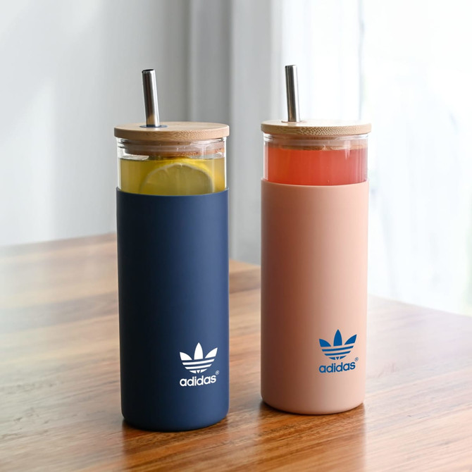 A drink bottle set featuring a navy blue tumbler and a pink tumbler, each with a bamboo lid and straw.