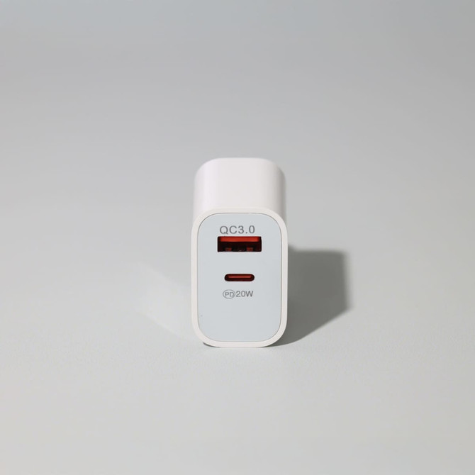 A white 20W fast charge adapter with a USB-C port and a logo on the front, set against a light background.