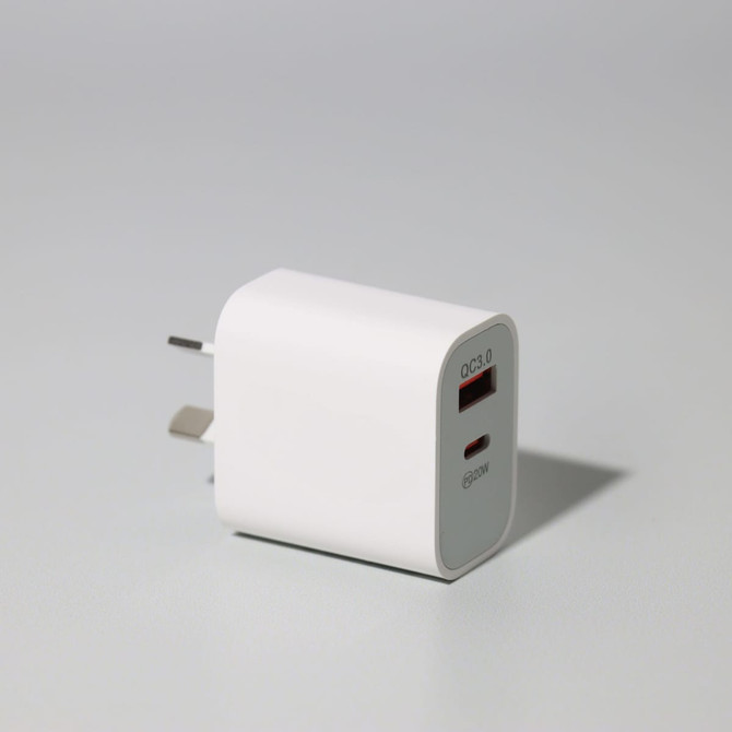 A white 20W fast charge adapter with two ports and a logo, suitable for travel.