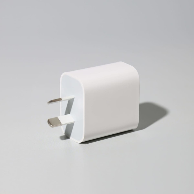 A white 20W fast charge adapter with two prongs, featuring a rounded design and a minimalist aesthetic.