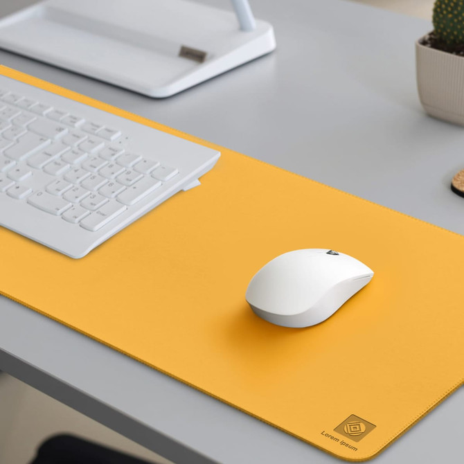 A bright yellow PU leather desk mat with a white mouse and a keyboard on a grey desk. It features a logo in one corner.