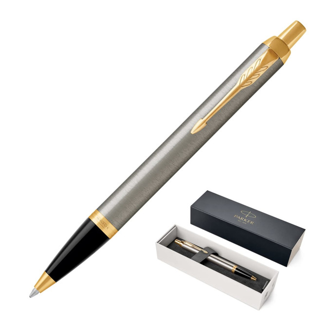 A brushed stainless steel ballpoint pen with gold accents, presented in a black box with branding.