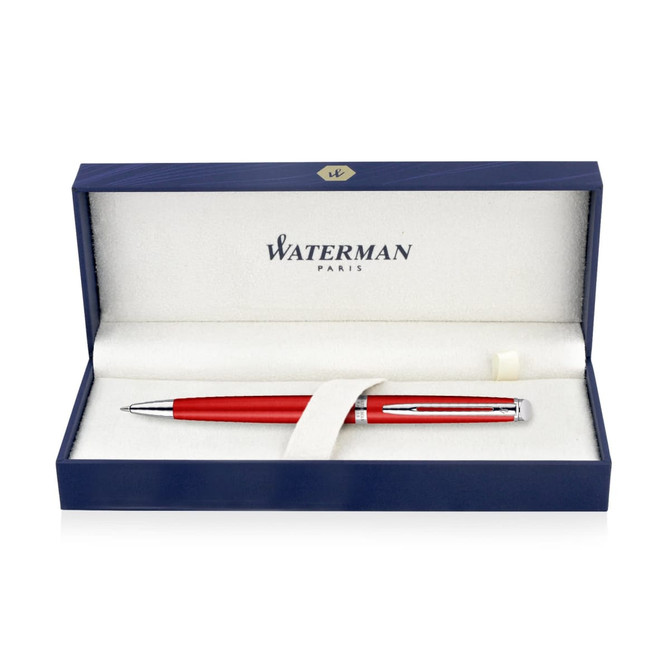 A metal ballpoint pen in comet red, presented in a navy blue box with a soft interior and a branding logo.