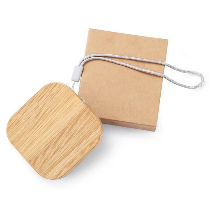 A square bamboo cable organiser with a silver strap, alongside a kraft paper packaging box.