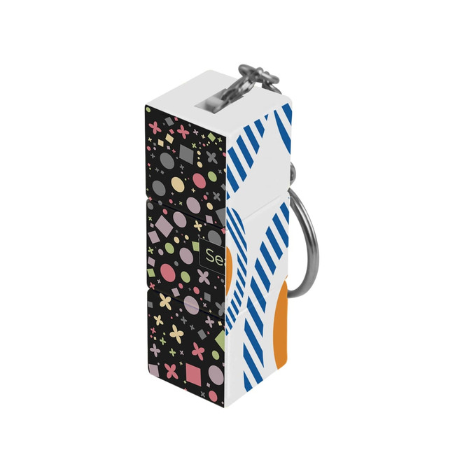 A custom square cube with keyrings featuring a colourful design of shapes and patterns, with a metallic keyring attachment.
