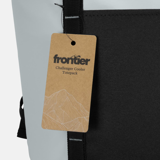 A grey and black cooler toting pack featuring a tag with a mountain design and a logo.