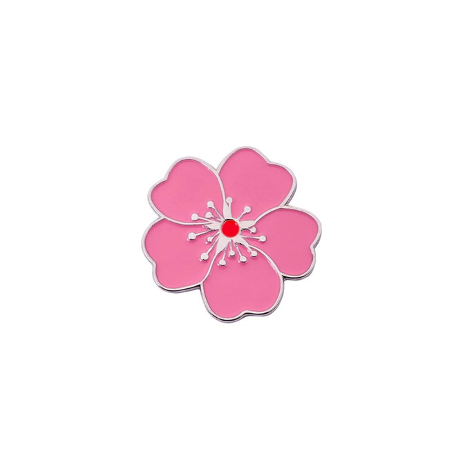 A pink soft enamel golf ball marker shaped like a flower, featuring a red centre and silver outline.