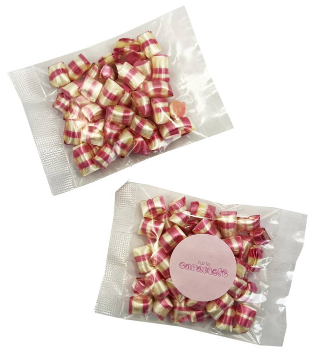 A packet of red and white striped humbug sweets, featuring a clear wrapper and a round label.