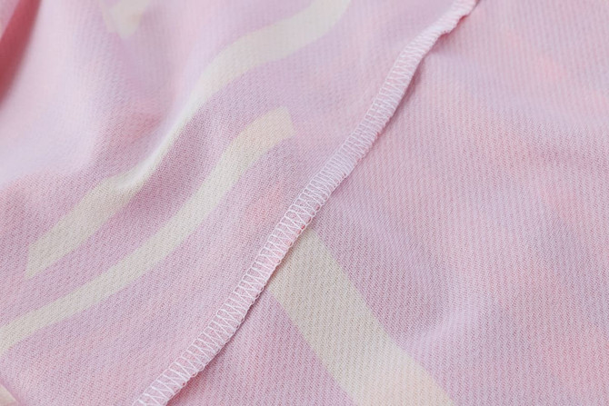 A pink micro mesh long sleeves shirt featuring a subtle pattern, with visible stitching along the edges.