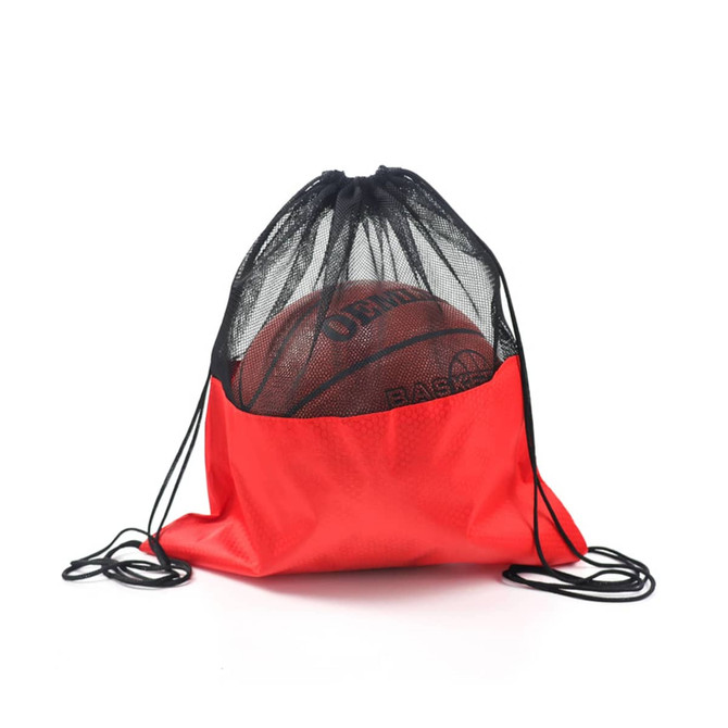 A red drawstring mesh backpack with a black top, containing a basketball inside. Features a logo.