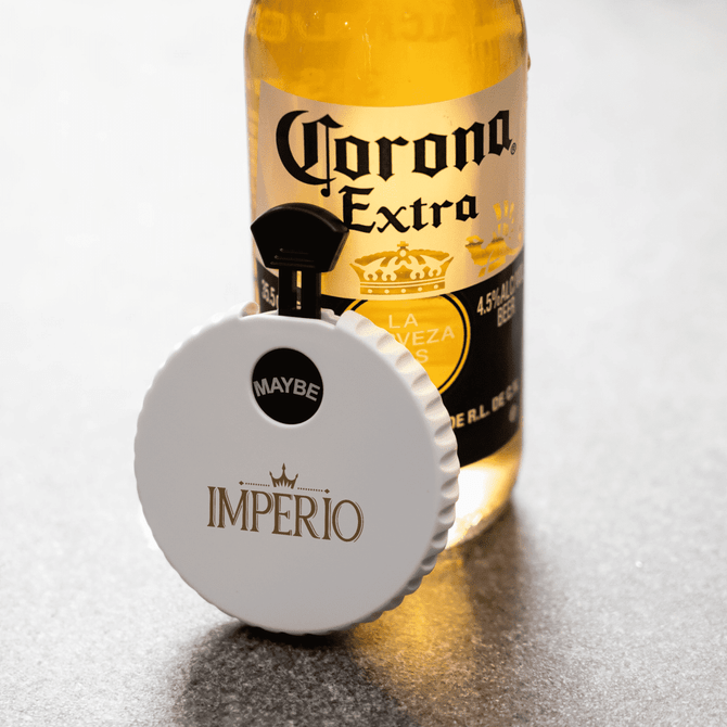 A drink bottle featuring a white bottle opener spinner, displaying the colours gold and black. It has a logo.