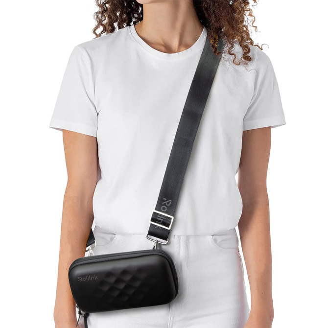 A black mini bag worn across the body, featuring a textured design and a long adjustable strap.