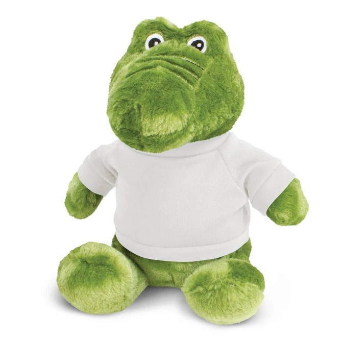 A green crocodile plush toy wearing a white shirt, featuring large eyes and a friendly expression.