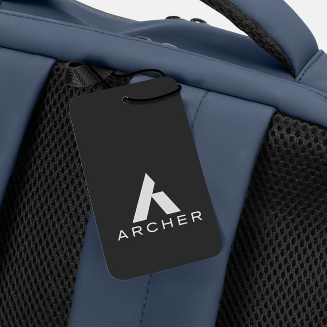 A blue soft-touch daily backpack with a mesh back and a tag featuring a logo.