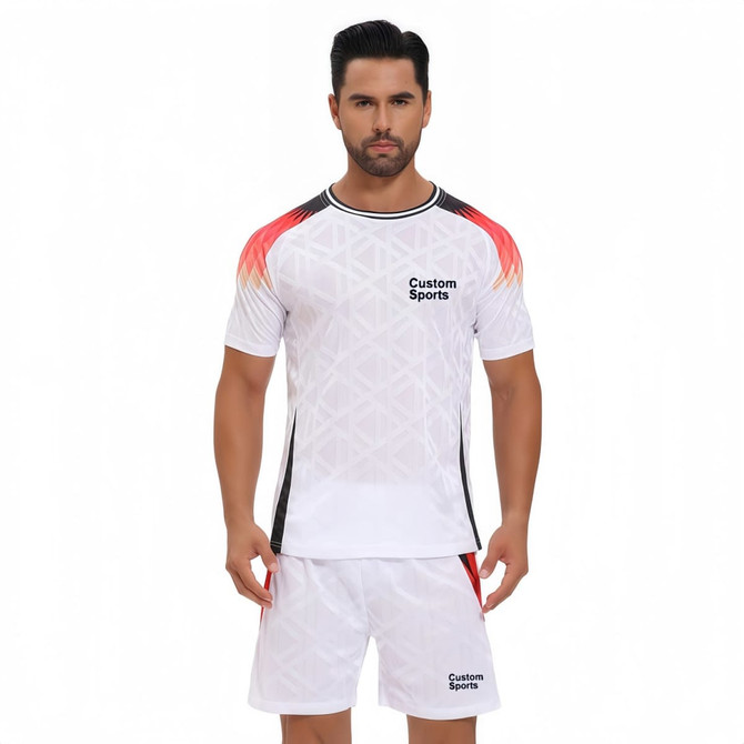 A crew neck raglan tee shirt in white with red and black accents, featuring a logo on the front, paired with matching shorts.