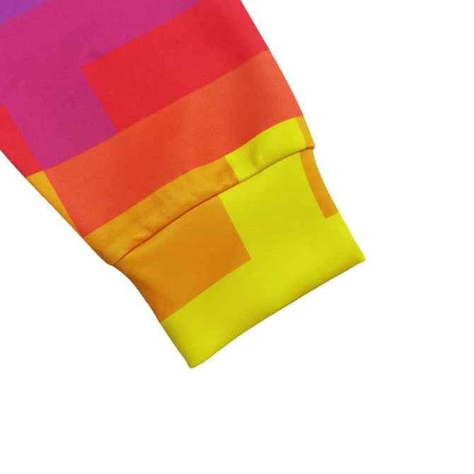 A vibrant polyester spandex hoodie sleeve featuring shades of pink, orange, and yellow with a patterned design.