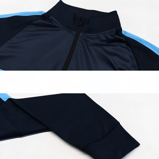 A high stand-up collar quarter-zip raglan jacket in navy blue with light blue accents and a logo.