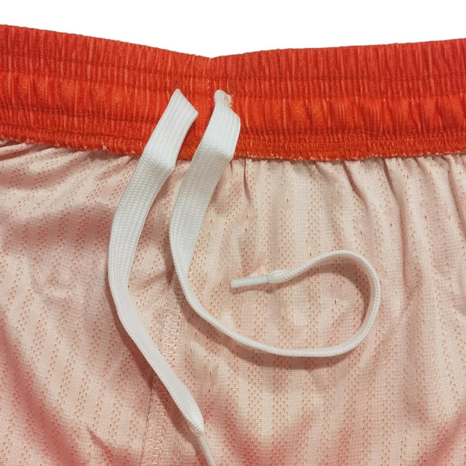 Breathable sport shorts in peach with an orange waistband and white drawstrings. Features a logo.