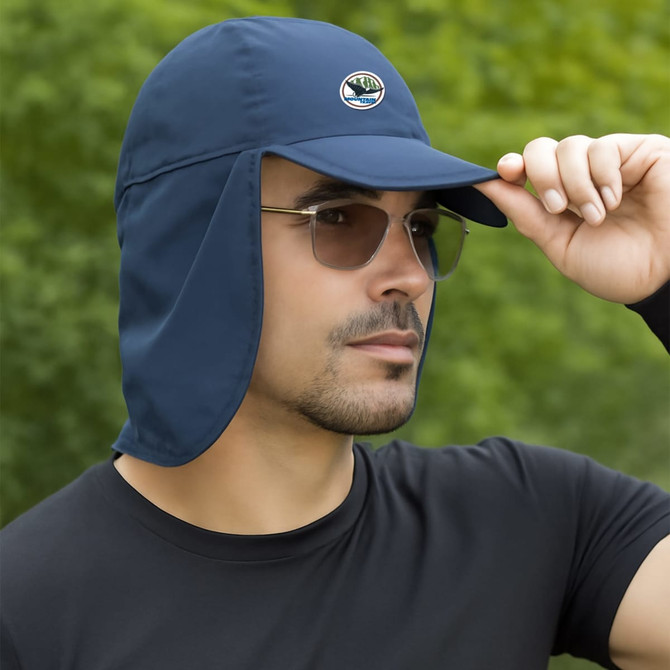A navy baseball cap with a neck flap worn by a man, featuring a logo on the front and sunglasses.