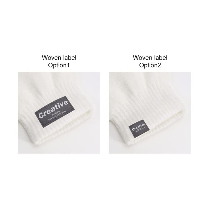 A pair of white knitted gloves featuring woven labels in different styles on the cuffs.