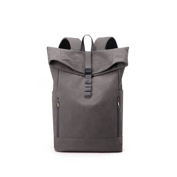 A grey canvas roll top vintage backpack with two side zippers and a logo on the front.