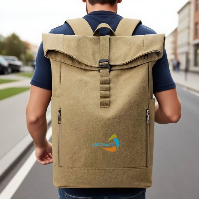 A vintage roll top backpack in khaki, worn on a person's back, with a logo on the front.