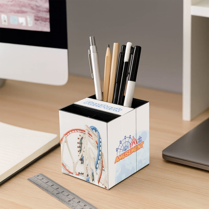 A three-panel foldable pen holder in white, featuring a colourful amusement park design, storing various pens and pencils.