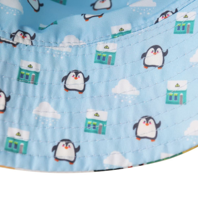 A light blue bucket hat featuring a playful penguin pattern and a logo on the inside edge.