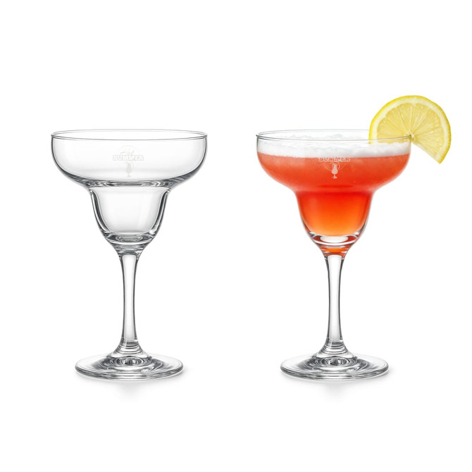 A pair of margarita glasses, one clear and one filled with a red drink garnished with a lemon slice.