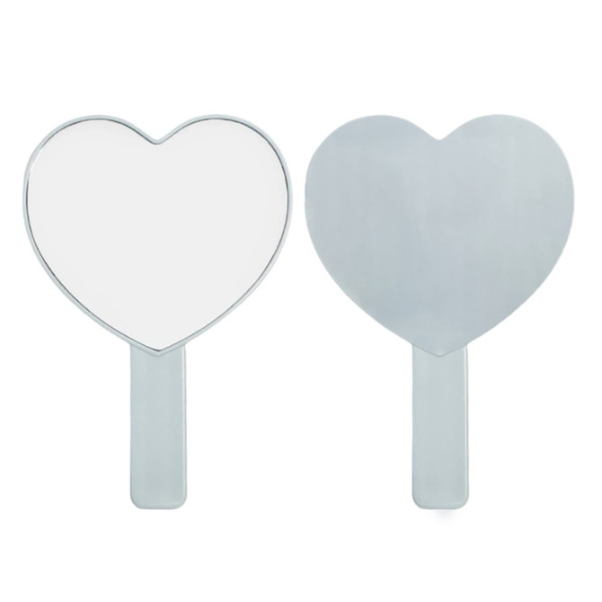 A heart-shaped handheld mirror with a shiny silver handle, reflecting a clear image on one side and a flat back on the other.