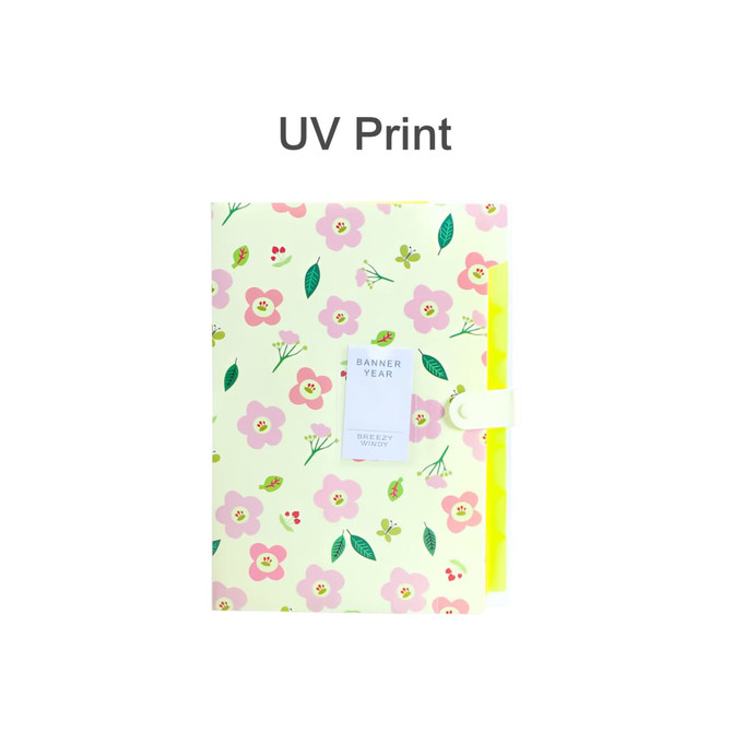 An expandable file folder in yellow covered with pink floral patterns, featuring a secure closure and a branding label.