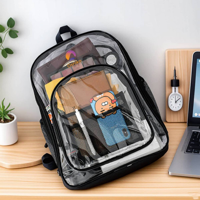 A transparent backpack featuring black edges, filled with various items including stationery and a cute character keychain.