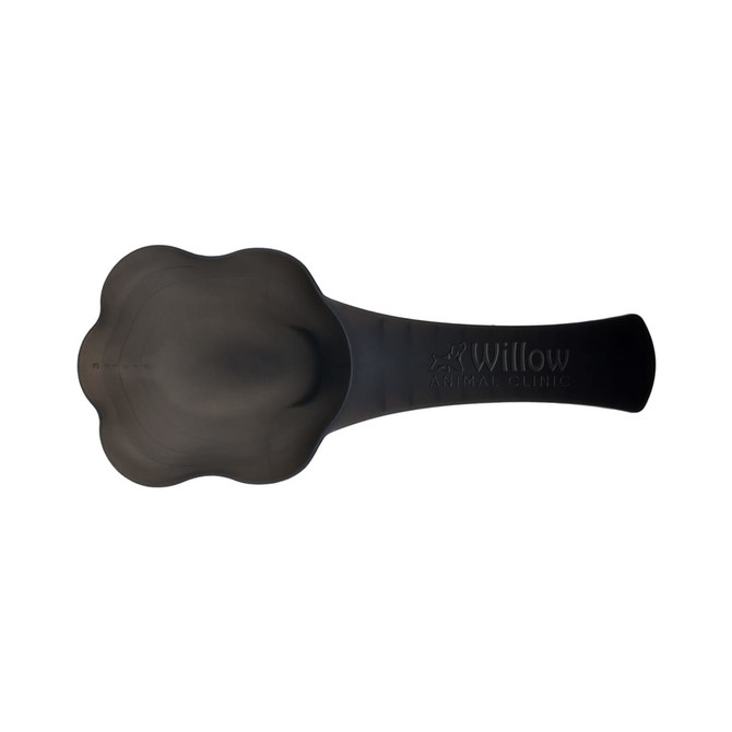 A black pet food scoop with a paw-shaped design and an engraved logo.
